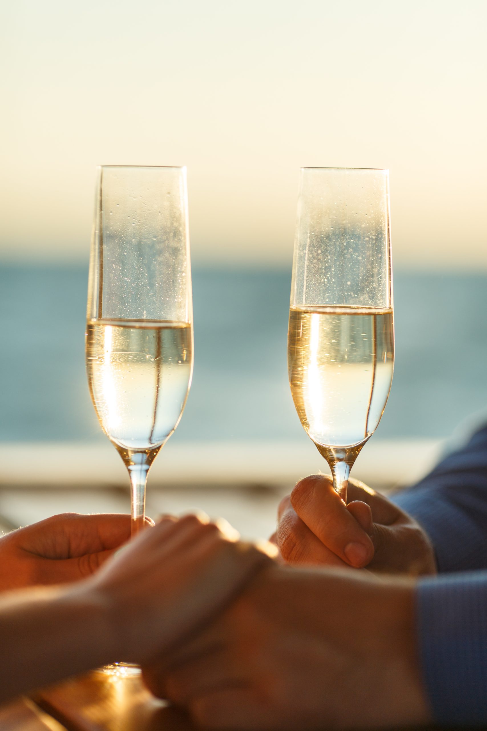 Happy couple drinks champagne on a yacht